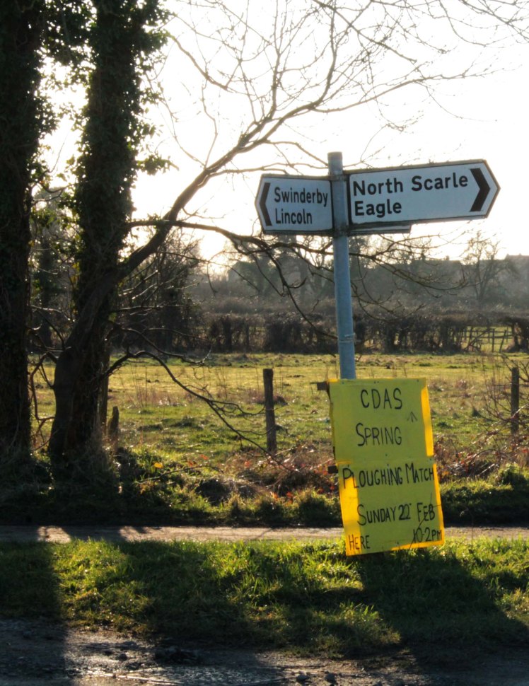 signpost with ploughing match sign